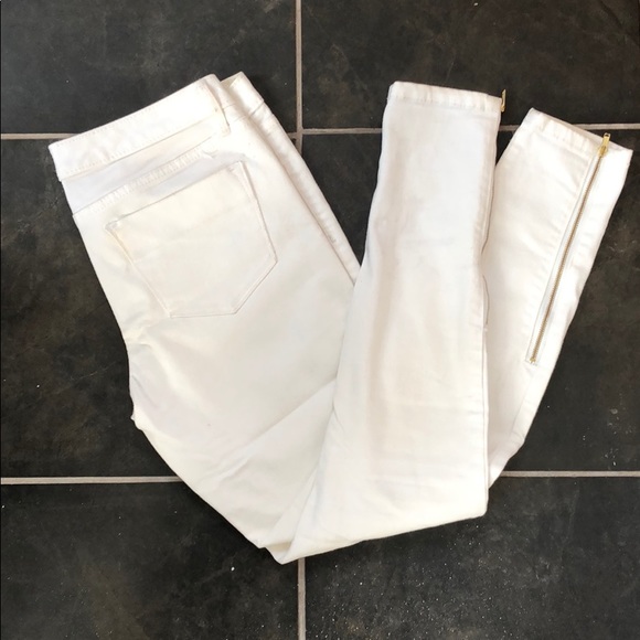 White denim leggings with gold zipper detail
